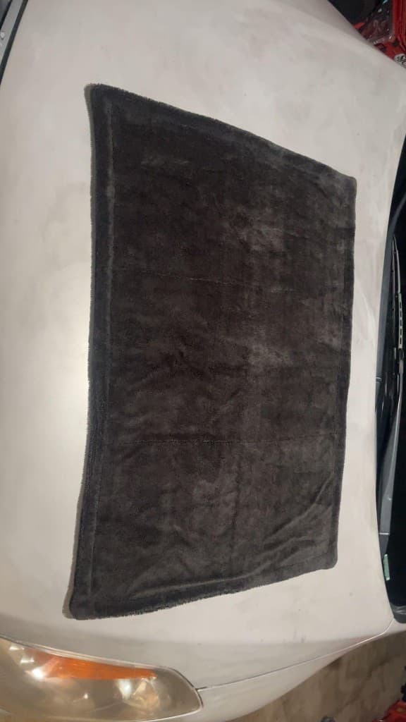 BlackFiber towel laid out on a customer's car hood after use